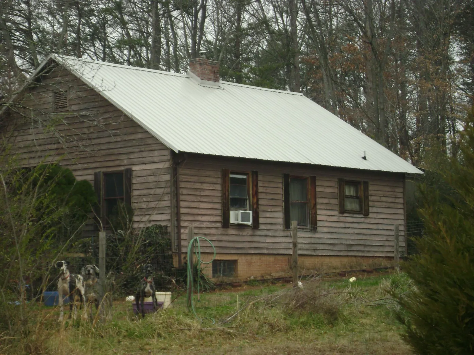 White metal roof on an old wood sided farmhouse, from a Metal Roof Installation job in Junction City