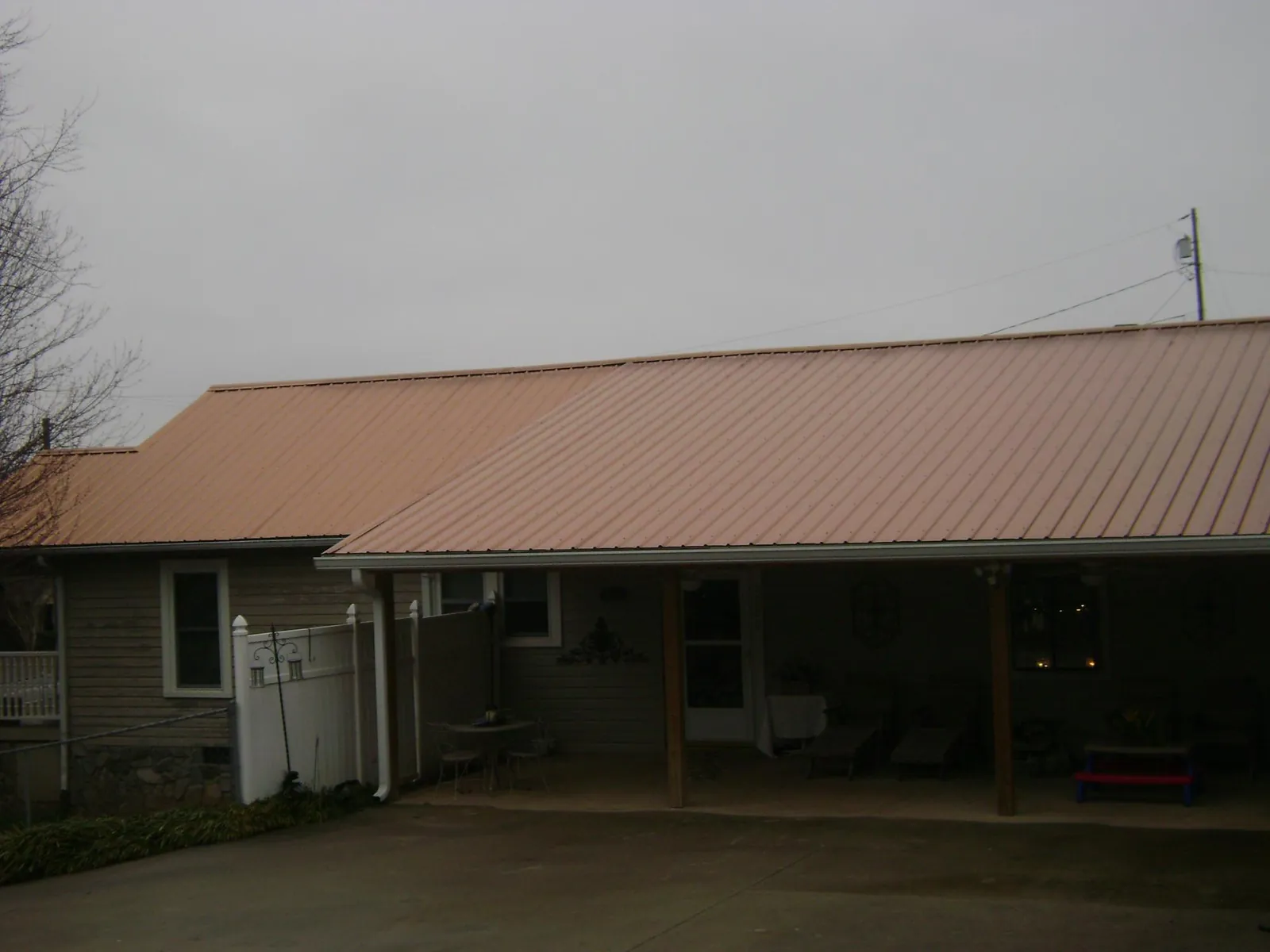 Copper toned metal roof over a wide covered patio in Junction City
